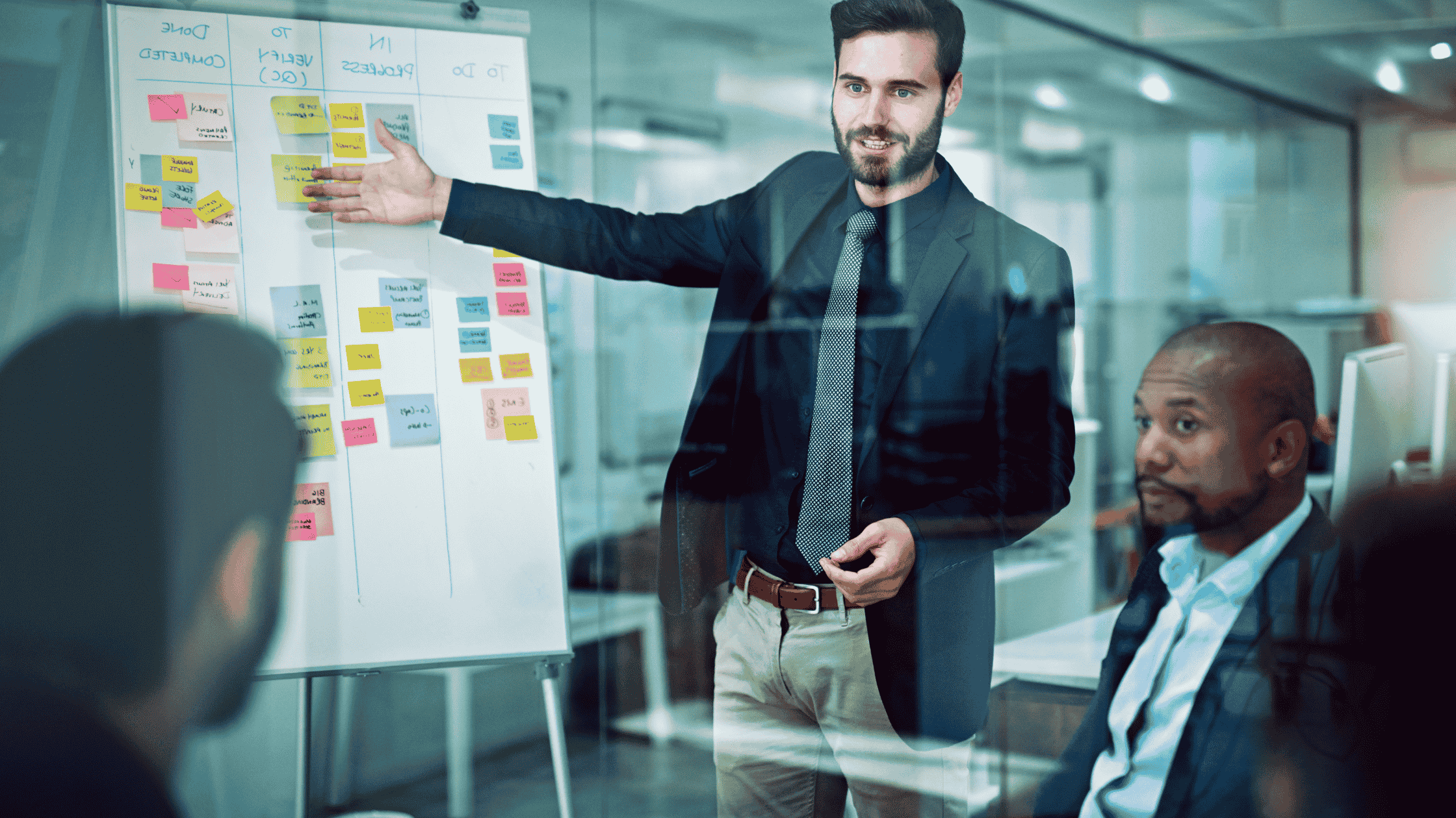 Marketing team discussing a strategy board during a meeting, planning conversational commerce ads and in-chat advertising approaches.