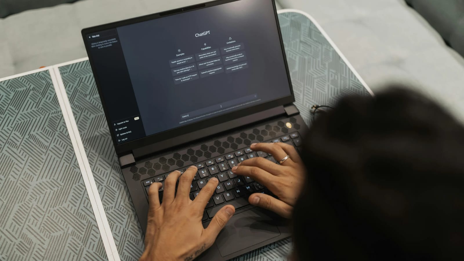 User typing on a laptop screen displaying ChatGPT, illustrating chatgpt ads vs google ads roi and modern AI-powered advertising.