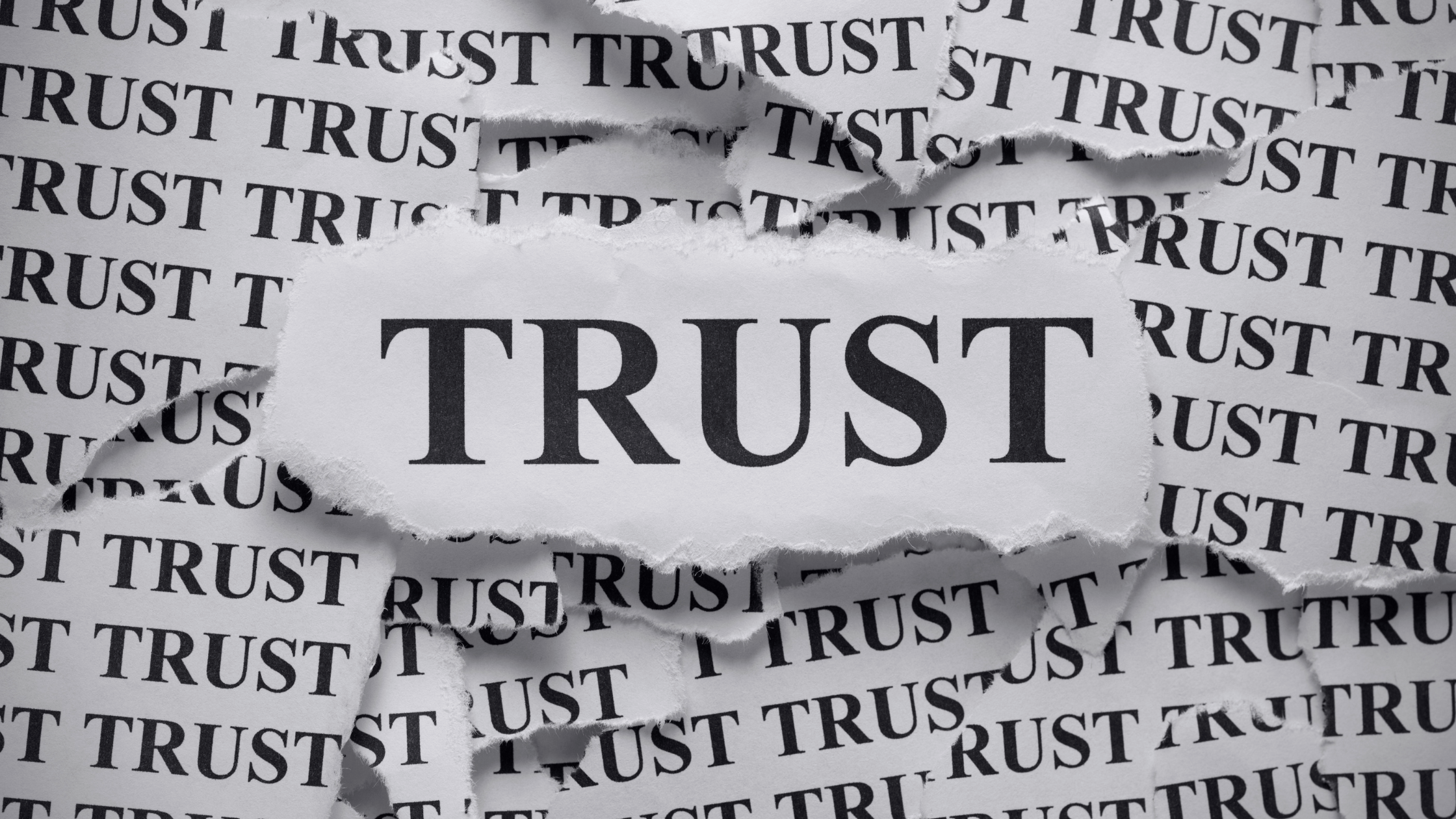 Torn paper revealing the word TRUST, symbolizing the foundation of a trust based advertising model and the growing importance of transparency in digital marketing.